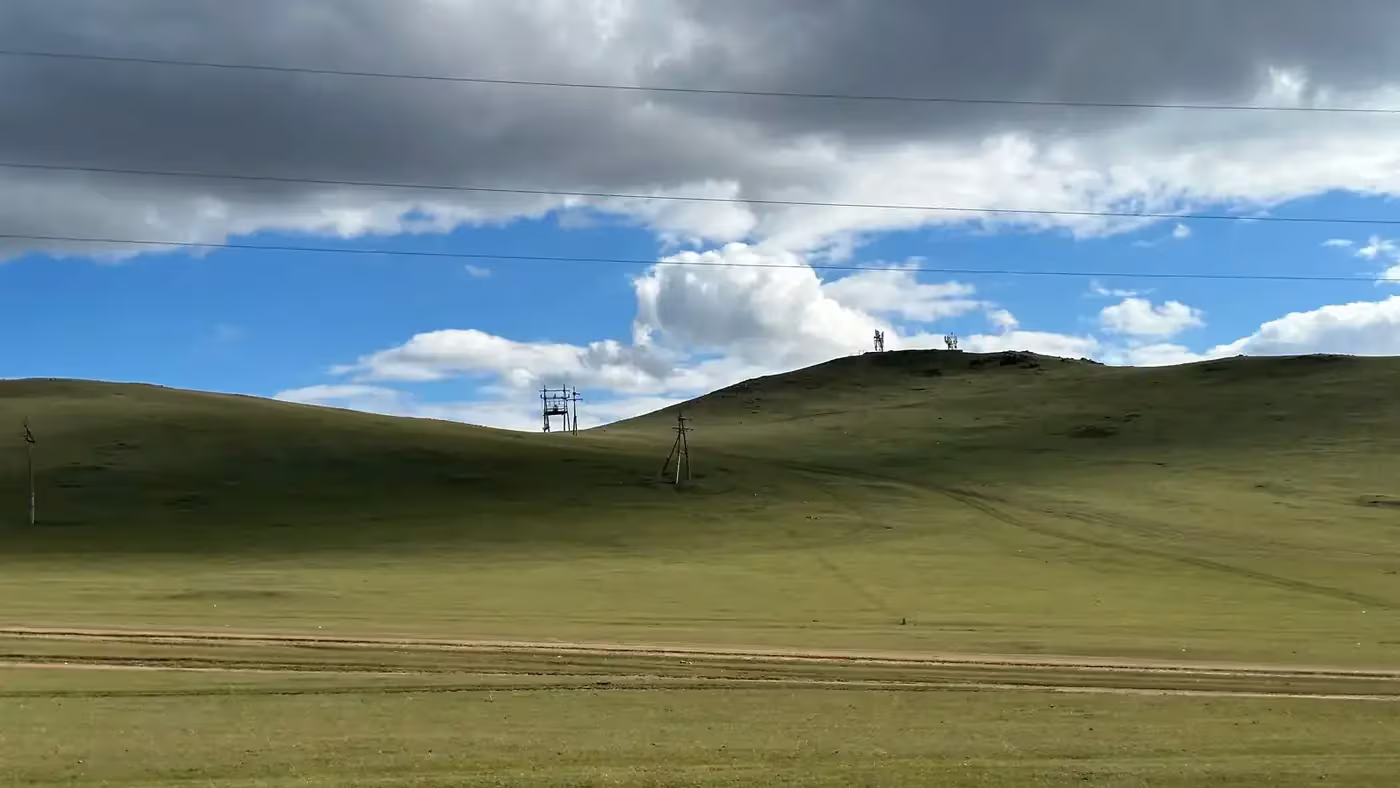 A solitary white ger on the central Mongolian steppe at golden hour